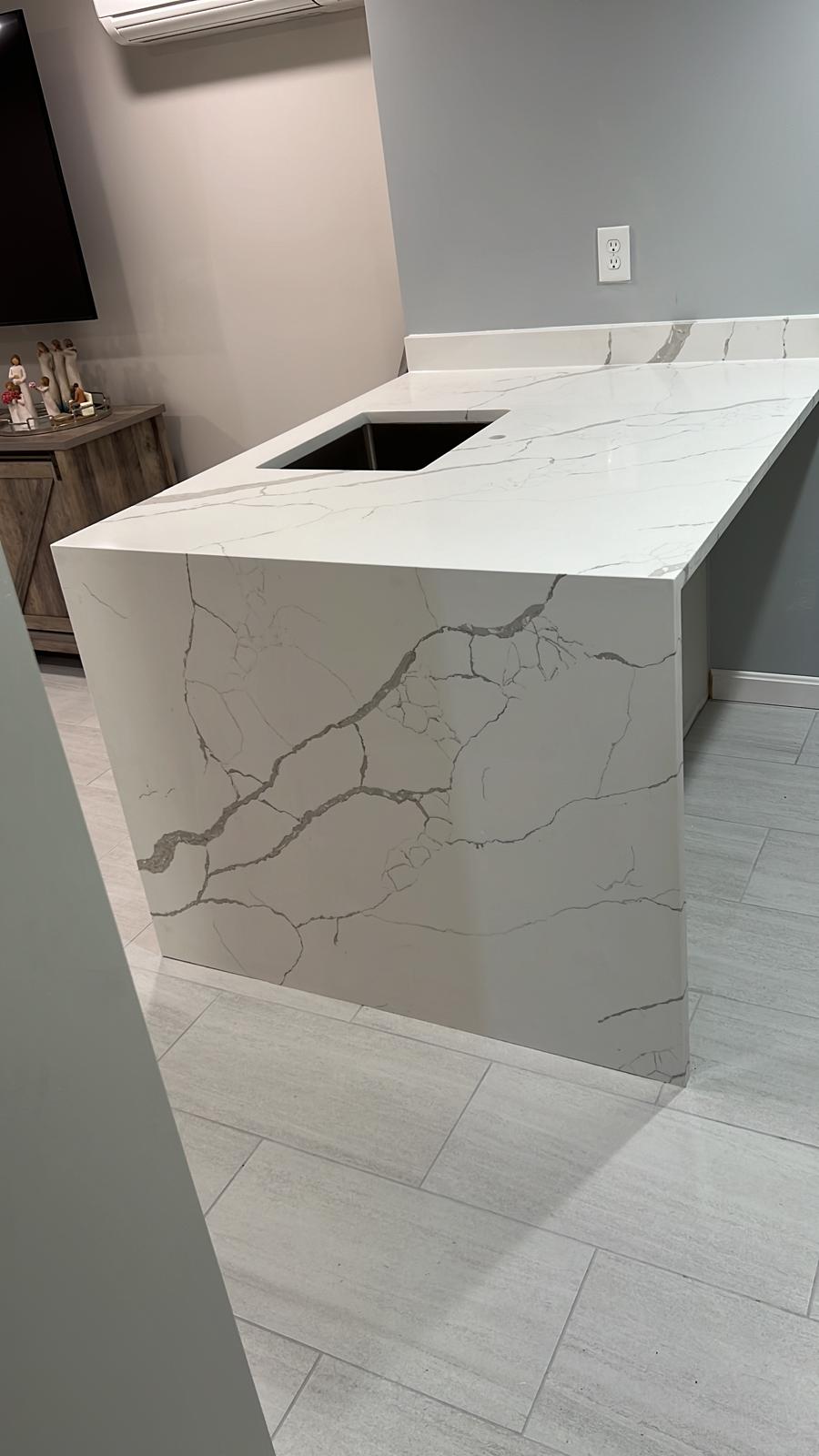 White quartz waterfall countertop installed by JLM Marble & Granite